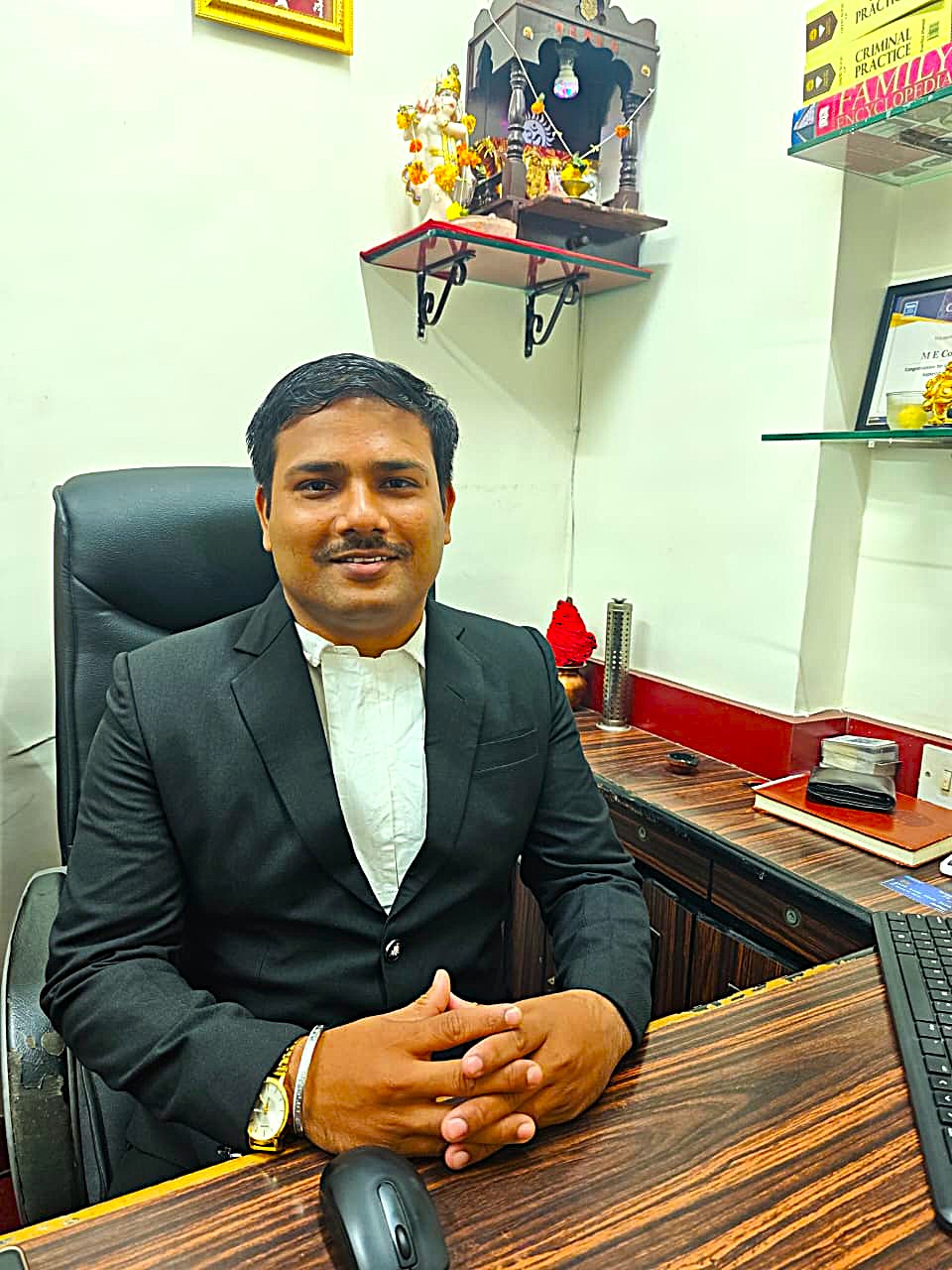 Adv. Eknath working at his office desk in Mumbai